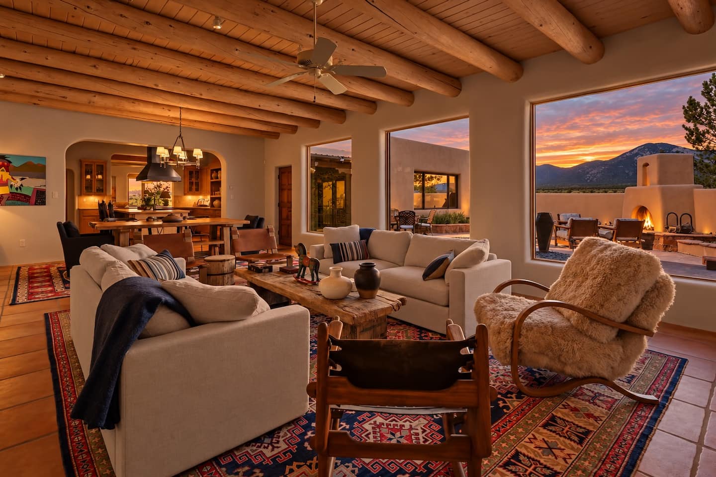Warm living room with viga ceiling, art and mountain views