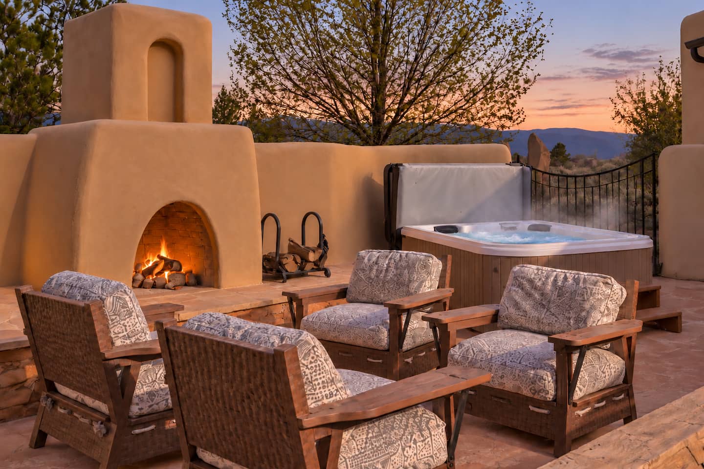Courtyard seating gathered around the outdoor fireplace at dusk